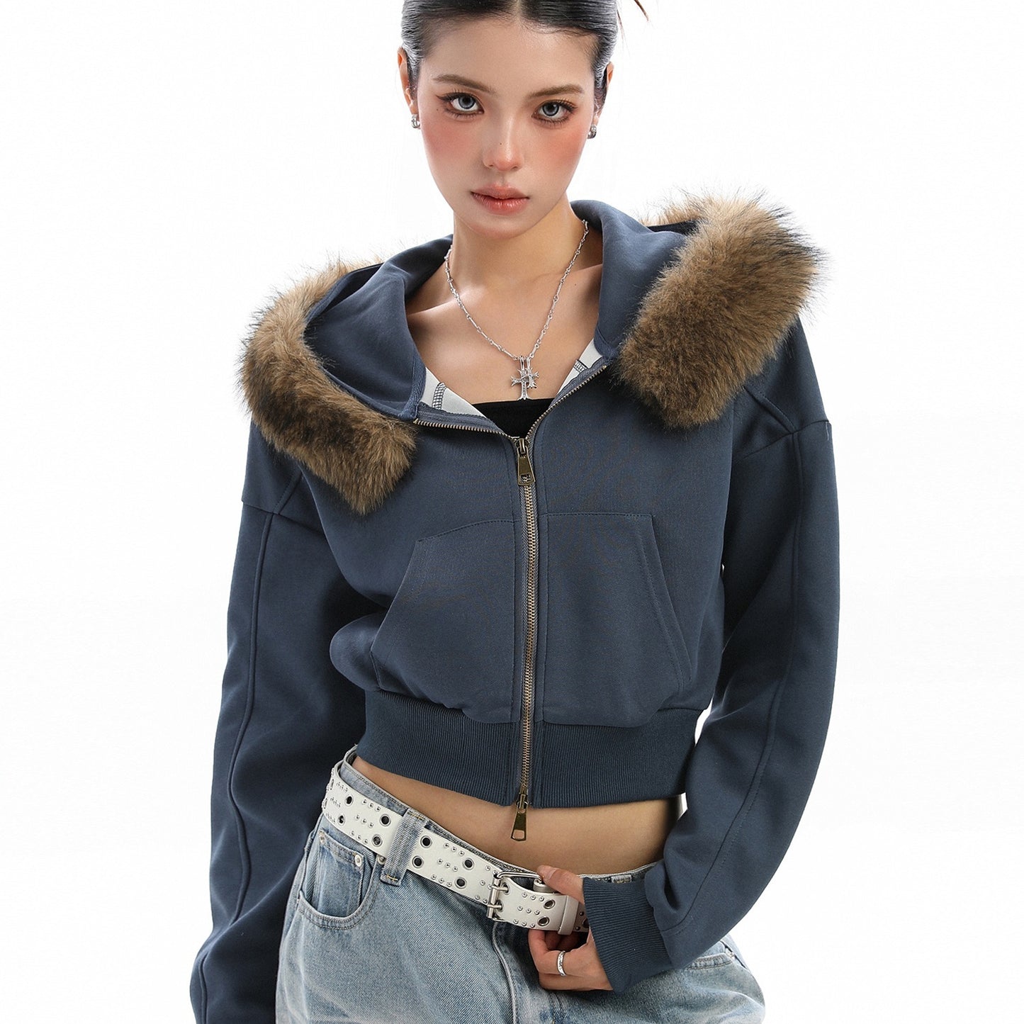 Person wearing a dark blue hoodie with fur-lined hood on a white background