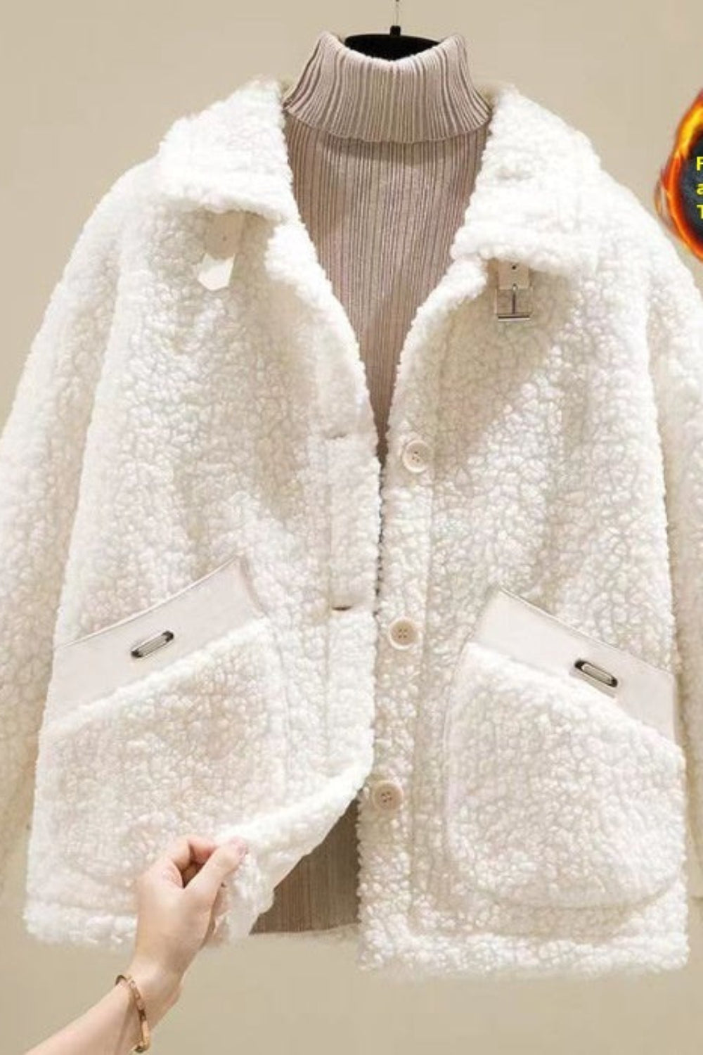 White fleece-lined jacket on a mannequin with a flame icon and text indicating fleece lining and thickening.