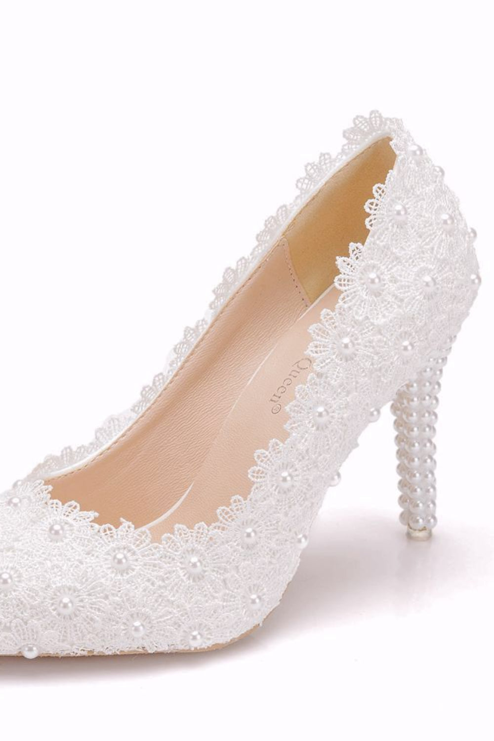 White high-heeled shoe with lace detailing on a white background