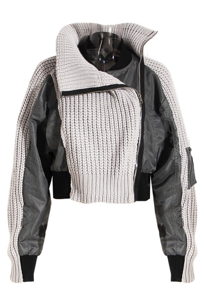 Two-tone jacket with knitted sleeves and black accents on a white background