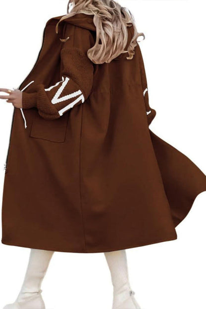 Brown coat with white trim worn by a person on a white background