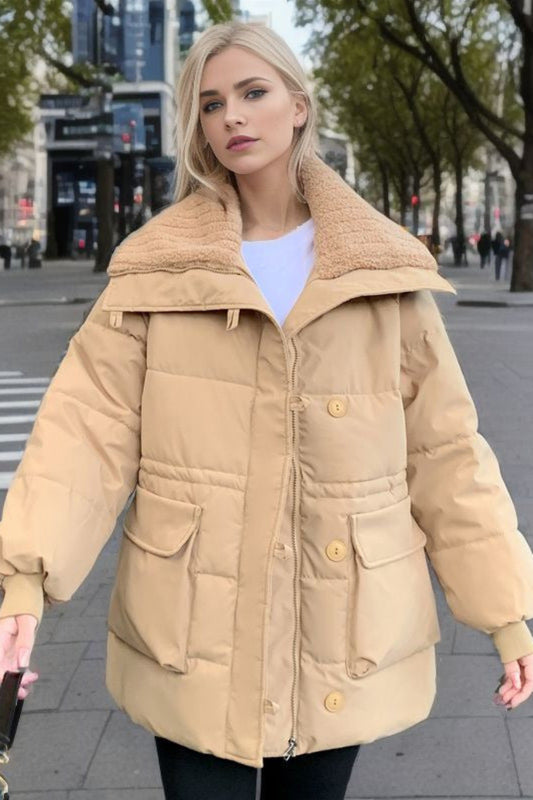 Woman wearing a beige puffer coat on a city street