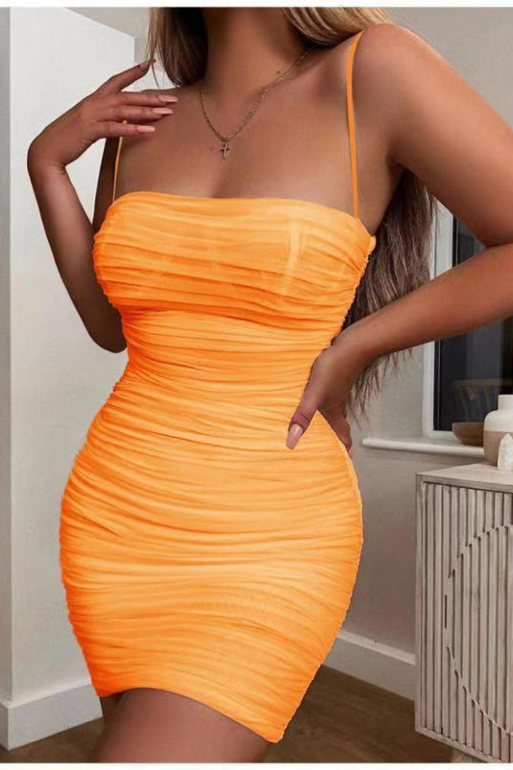 Orange dress worn by a person in an indoor setting