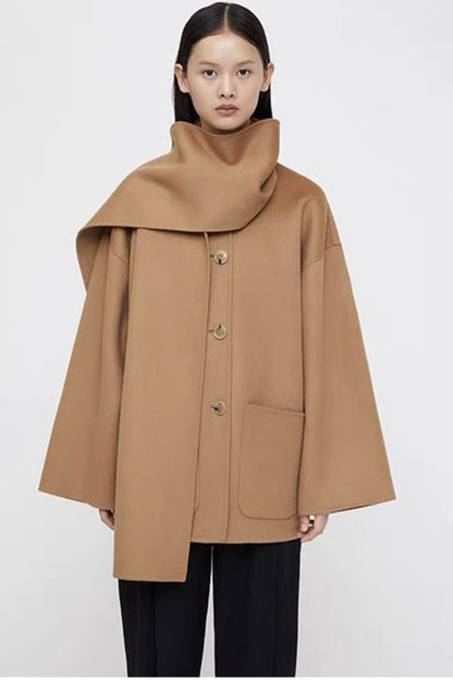 Woman wearing a tan coat on a white background