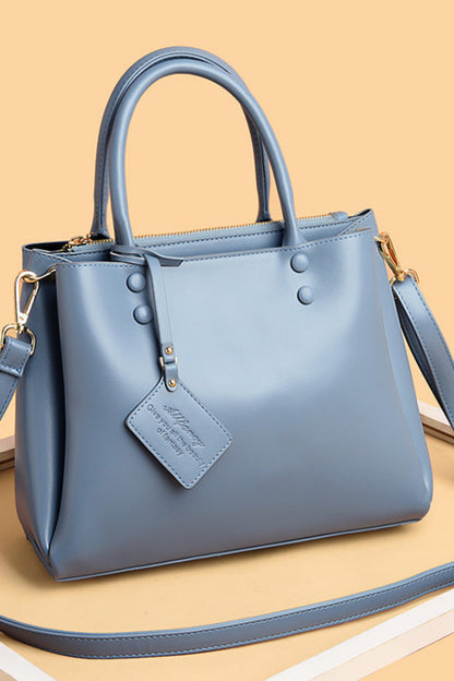 Blue handbag with a strap on a beige background