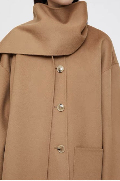 Close-up of a brown coat with a high collar and buttons on a white background