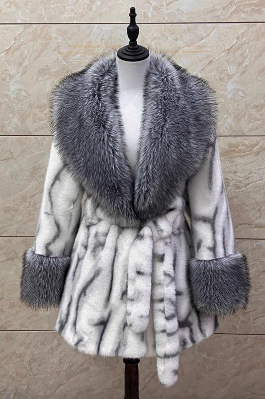 Fur-trimmed coat on a mannequin against a beige marble background