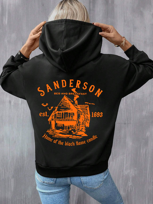 Person wearing a black hoodie with orange 'Sanderson Bed and Breakfast' design on the back against a gray background