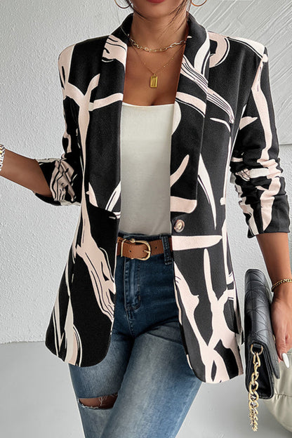 Person wearing a black and beige patterned blazer with a white top and jeans, holding a black handbag.