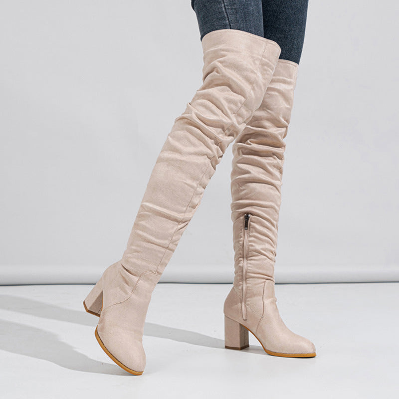 Beige knee-high boots on a white background