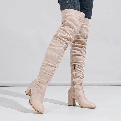 Beige knee-high boots on a white background