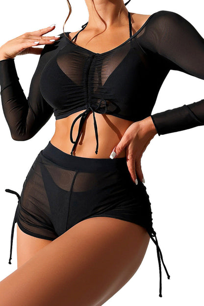 Black sheer long-sleeve top and shorts set on a white background