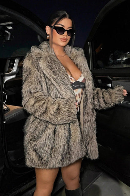 Person wearing a fur coat and sunglasses getting out of a car at night.