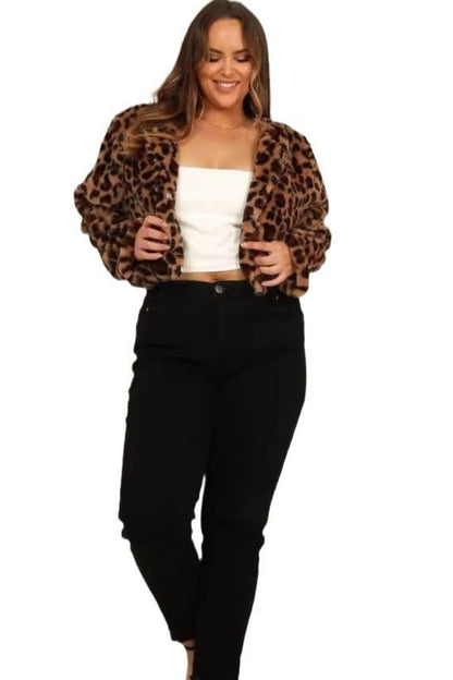 Woman wearing a leopard print jacket, white top, and black pants on a white background